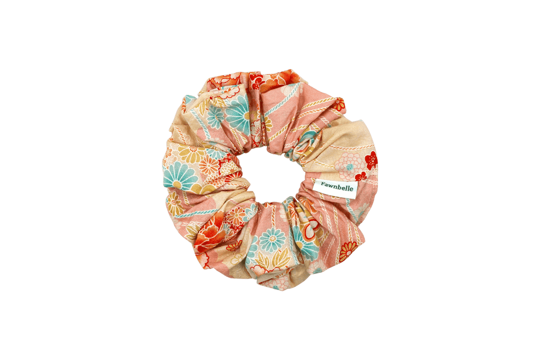 Floral patterned scrunchie with brand label on a black background cotton