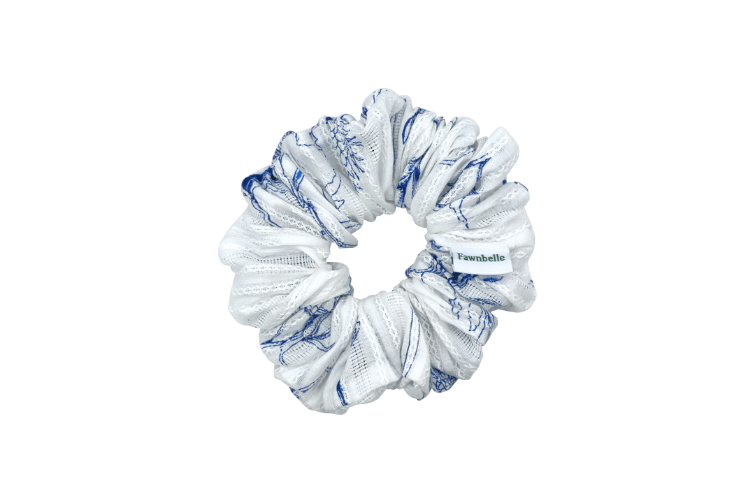 White scrunchie with blue patterns on a black background cotton