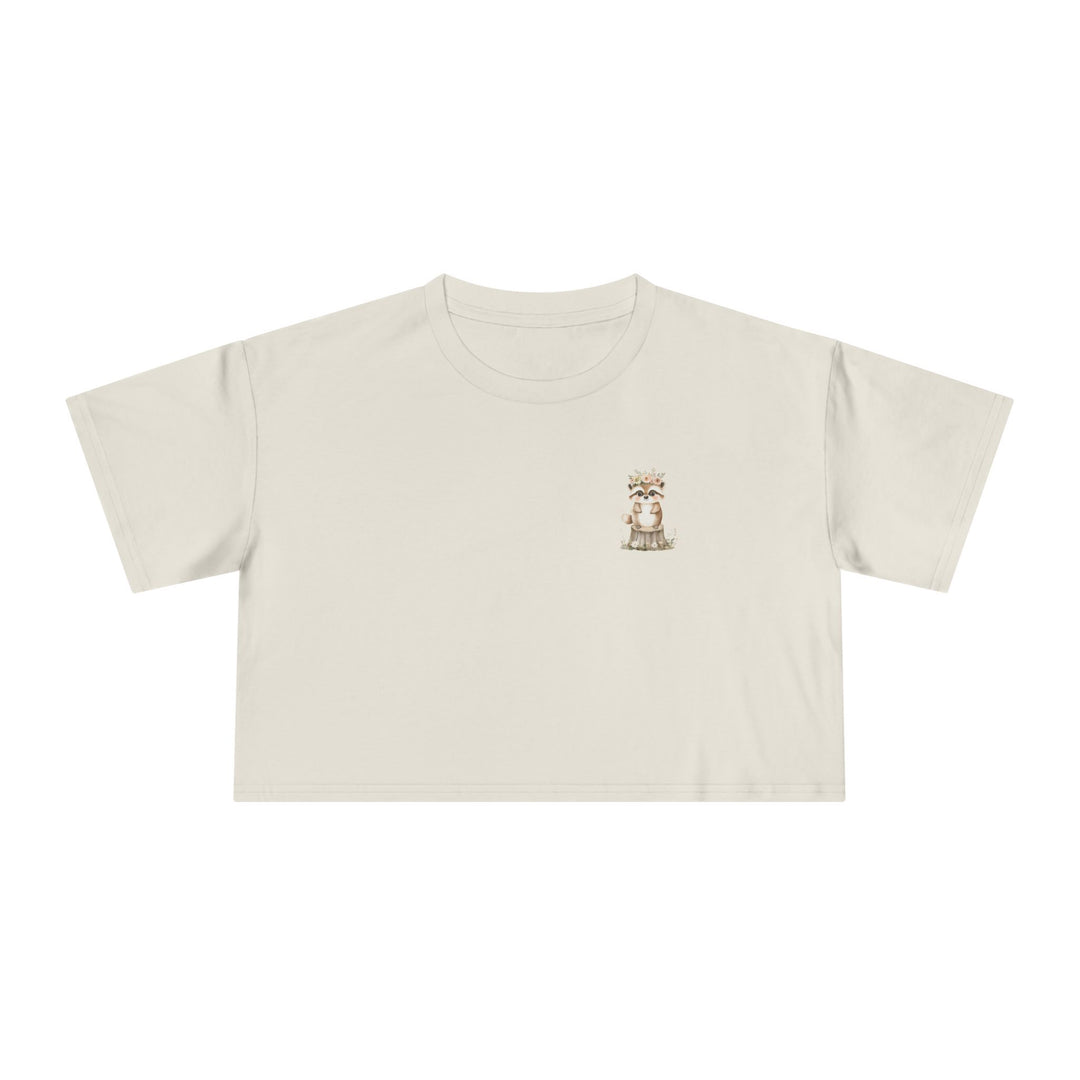 Women's cream crop top with a small watercolour raccoon illustration wearing a floral crown, Norwynd woodland nature apparel